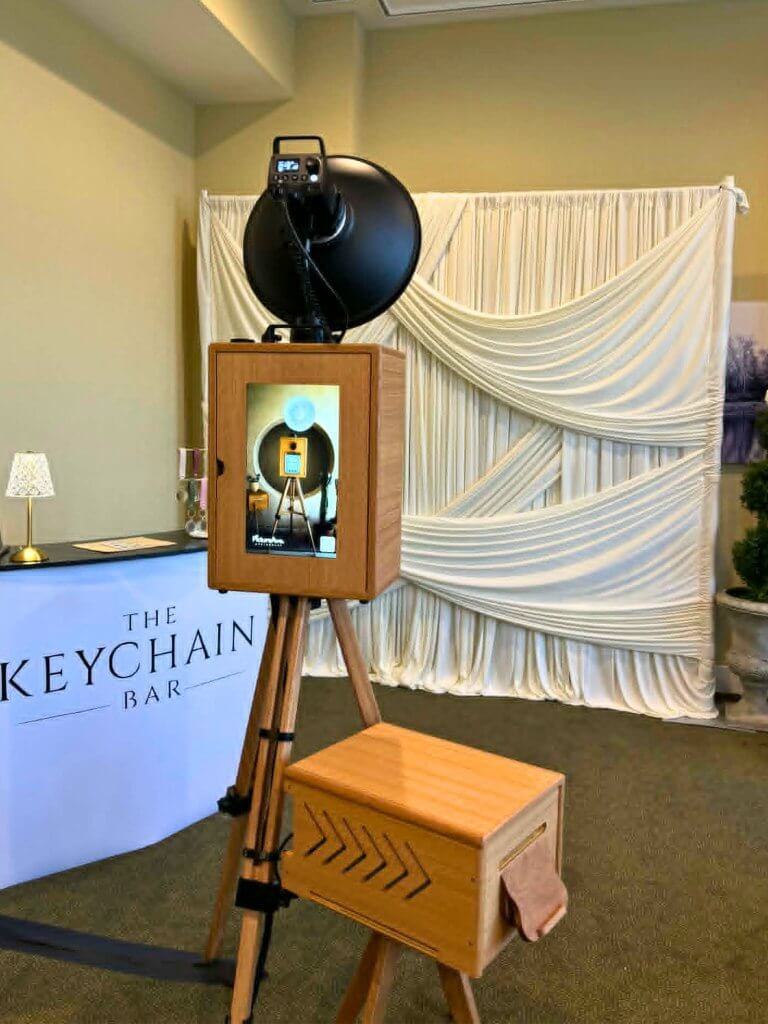 Luxury wedding photo booth with signature Ivory curtain backdrop